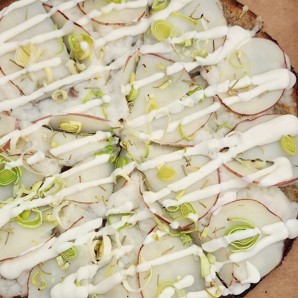 Pizza Verde's potato and leek atop a cauliflower crust allows everyone to enjoy a hot slice. (Courtesy)