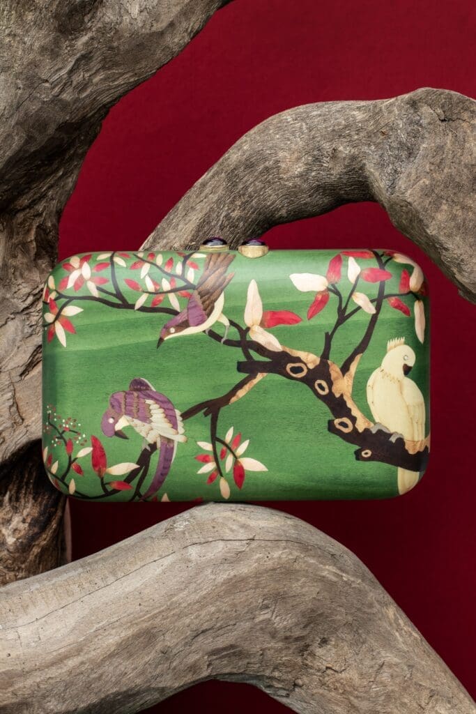 Green bird marquetry clutch with diamonds and pink tourmaline clasp.