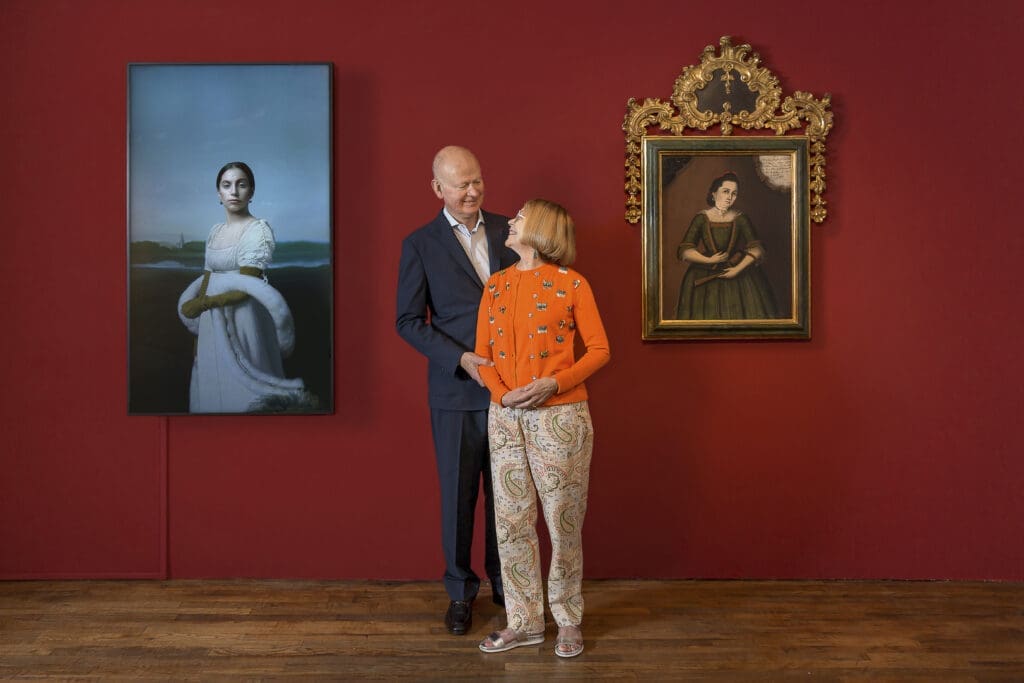 Carl and Marilynn Thoma with (from left) Robert Wilson’s "Lady Gaga: Mademoiselle Caroline Rivière," 2013, and Andrés Solano’s "Portrait of Ana Josepha de Castañeda y de la Reguera," 1776, at the Carl & Marilynn Thoma Foundation. (Photo by Tira Howard)