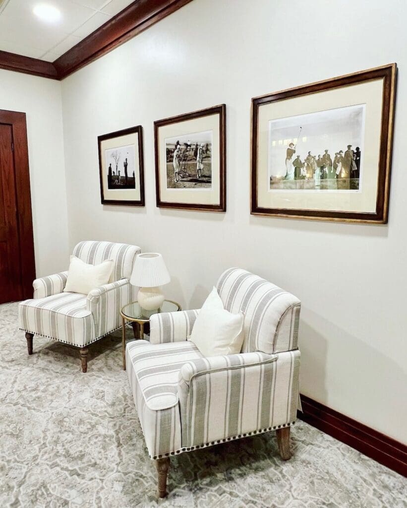 (After) The vintage golf photos are now at the entrance to the Ladies' Lounge.