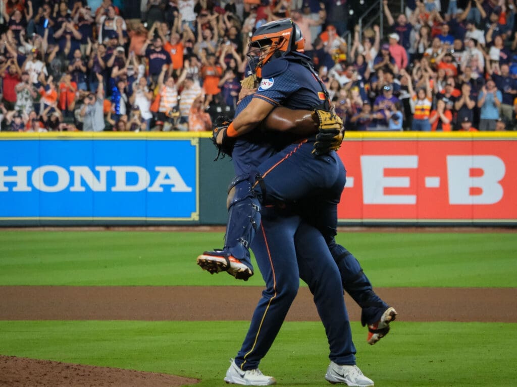 Houston Astros pitcher Ronel Blanco lifted  catcher Yainer Diaz in his arms after throwing a no hitter. (Photo by F. Carter Smith) 