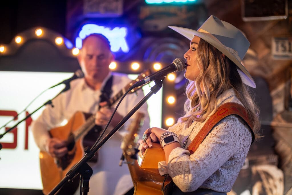 Gary Patterson joins Olivia Harms on stage to greet guests to the party. (Photo by Olaf Growold)