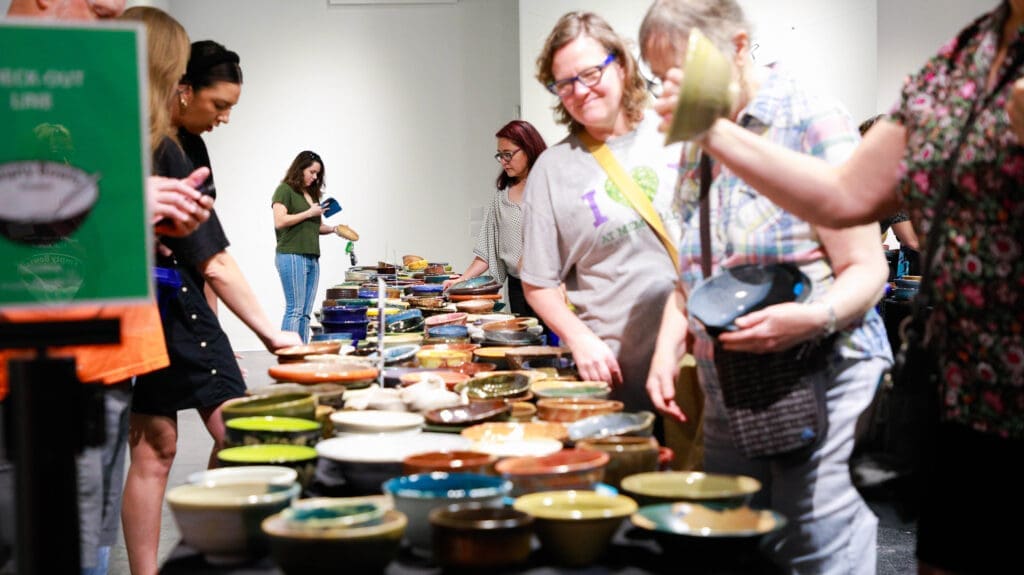 People peruse bowls at Empty Bowls Houston. (Courtesy Empty Bowls Houston)