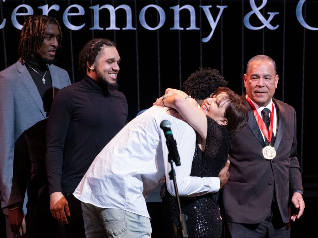 University of Houston forward Terrance Arceneaux gets a big hug from Karen Sampson as Ja'Vier Francis, Emanuel Sharp and Kelvin Sampson look on. (Photo by F. Carter Smith)