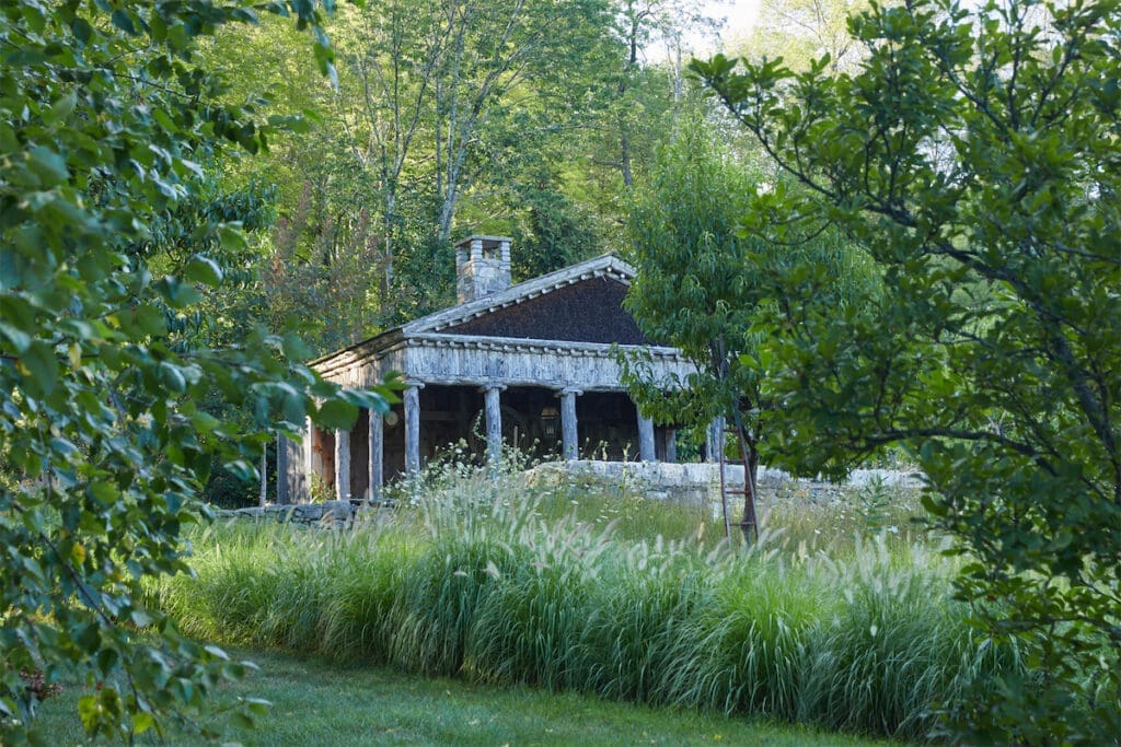 The idea for the pool house’s weathered Greek temple architecture came from an 18th century book on garden follies that Williams discovered in France. (Photo by Annie Schlechter)