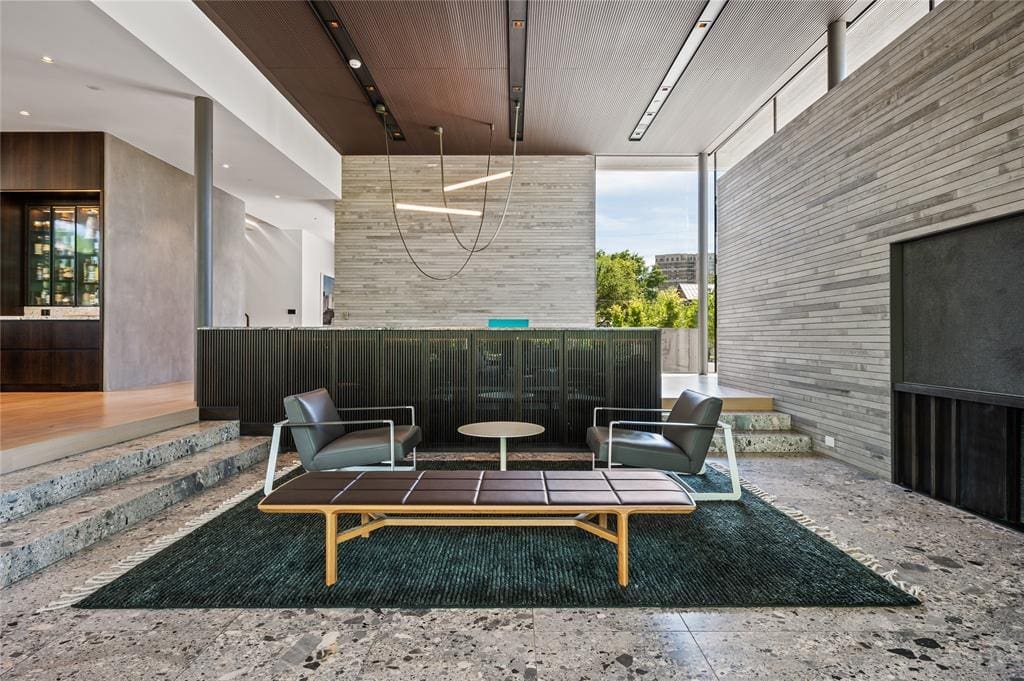 The living area feels intimate in the sprawling, glass-lined space.