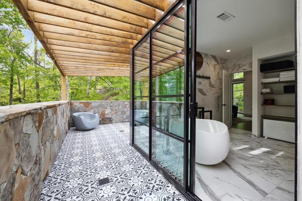 The bathroom has a covered balcony, perfect for admiring views in the heart of The Woodlands. (Photo by TK Images)