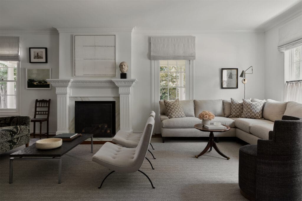 In the living room, 1950s Milo Baughman scoop chairs for James Manufacturing. Slate coffee table, 1960s, from the Netherlands. MGBW sectional. Studio Ashby swivel chair in Kufri upholstery. Antique Regency-style coffee table from England. Lumfardo Luminaires sconce. French 19th-century silver-leaf mirror from 1stdibs. (Photo by Trevor Parker)