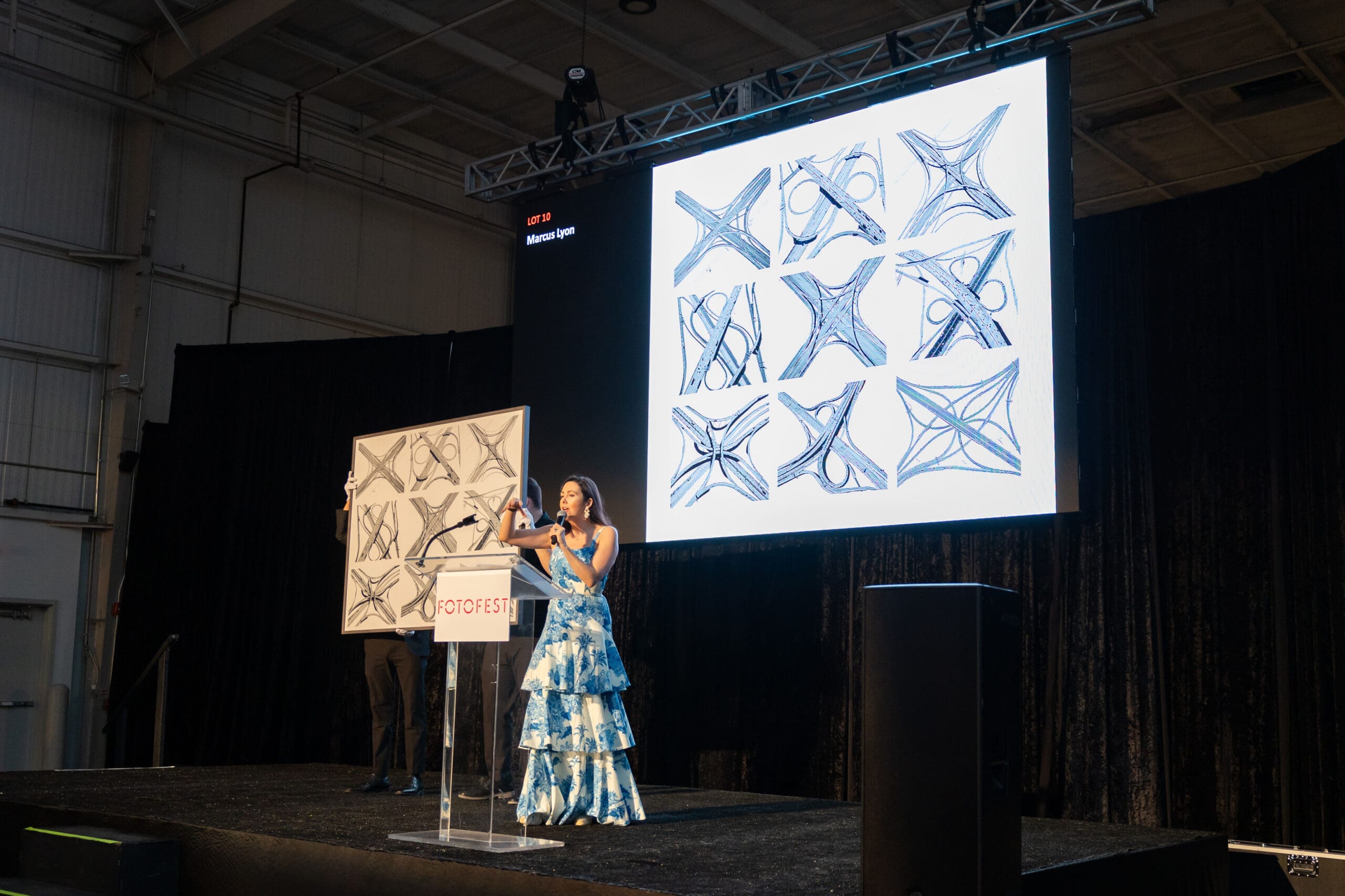 Auctioneer Jacqueline Towers-Perkins with Marcus Lyon's <em>Intersection</em> at FotoFest's 2024 Biennial Fine Print Auction and Gala. (Photo by Melissa Taylor)