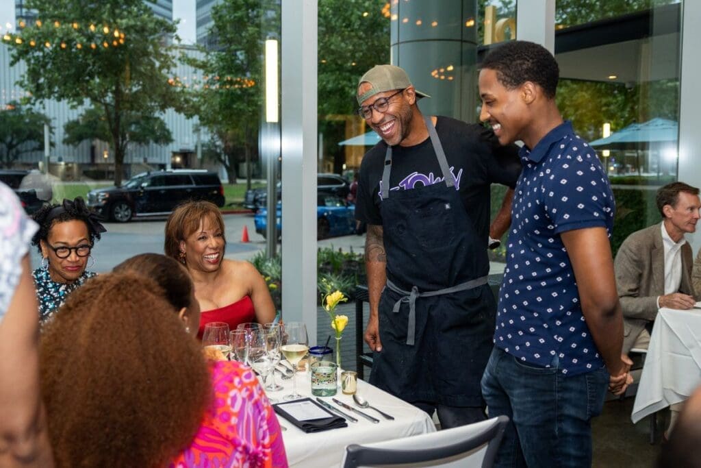 Chef Chris Williams and dancer Eric Best visiting with guests at the Houston Ballet 'Raising the Barre' dinner at Carocal. (Photo by Melissa Taylor)