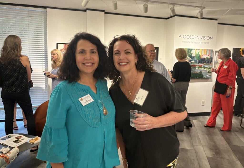 Jenny Carattini-Wright (l) and Annette Palmer at the opening for "A Golden Vision" show at the offices of The Woodlands Arts Council.  The exhibit runs through July 11. (Photo by Laura Landsbaum)