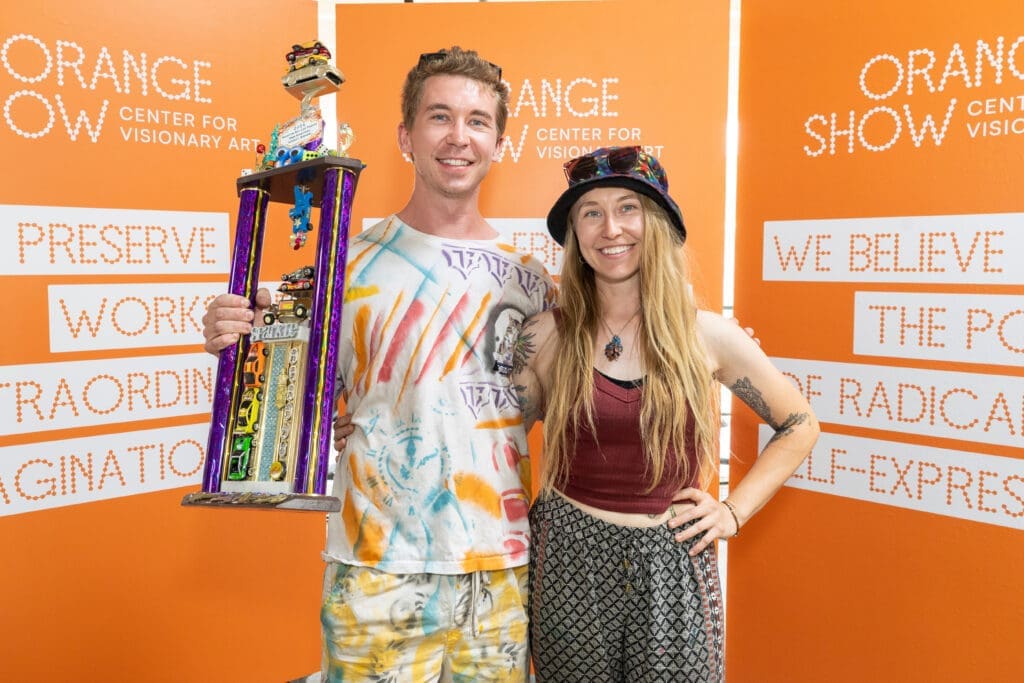 Kyle & Claire Johnson accept Ann Harithas Legacy Award for "The Ploppet" at the Orange Show's Art Car Award Ceremony. (Photo by Emily Jaschke) 