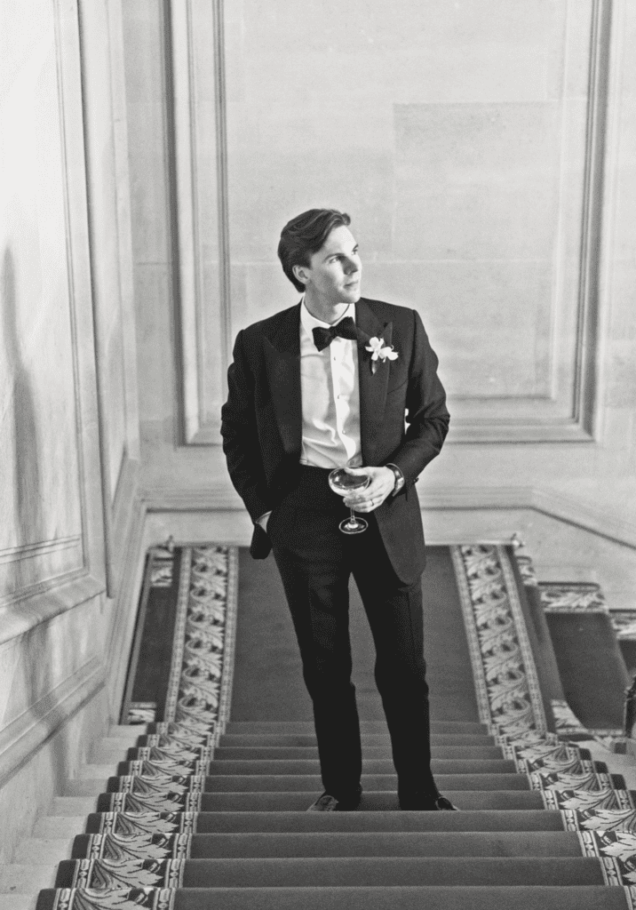 Groom Mack Abbot takes moment on the stairs of Cercle de I’Union Interalliée. (Photo by John Cain Photography)