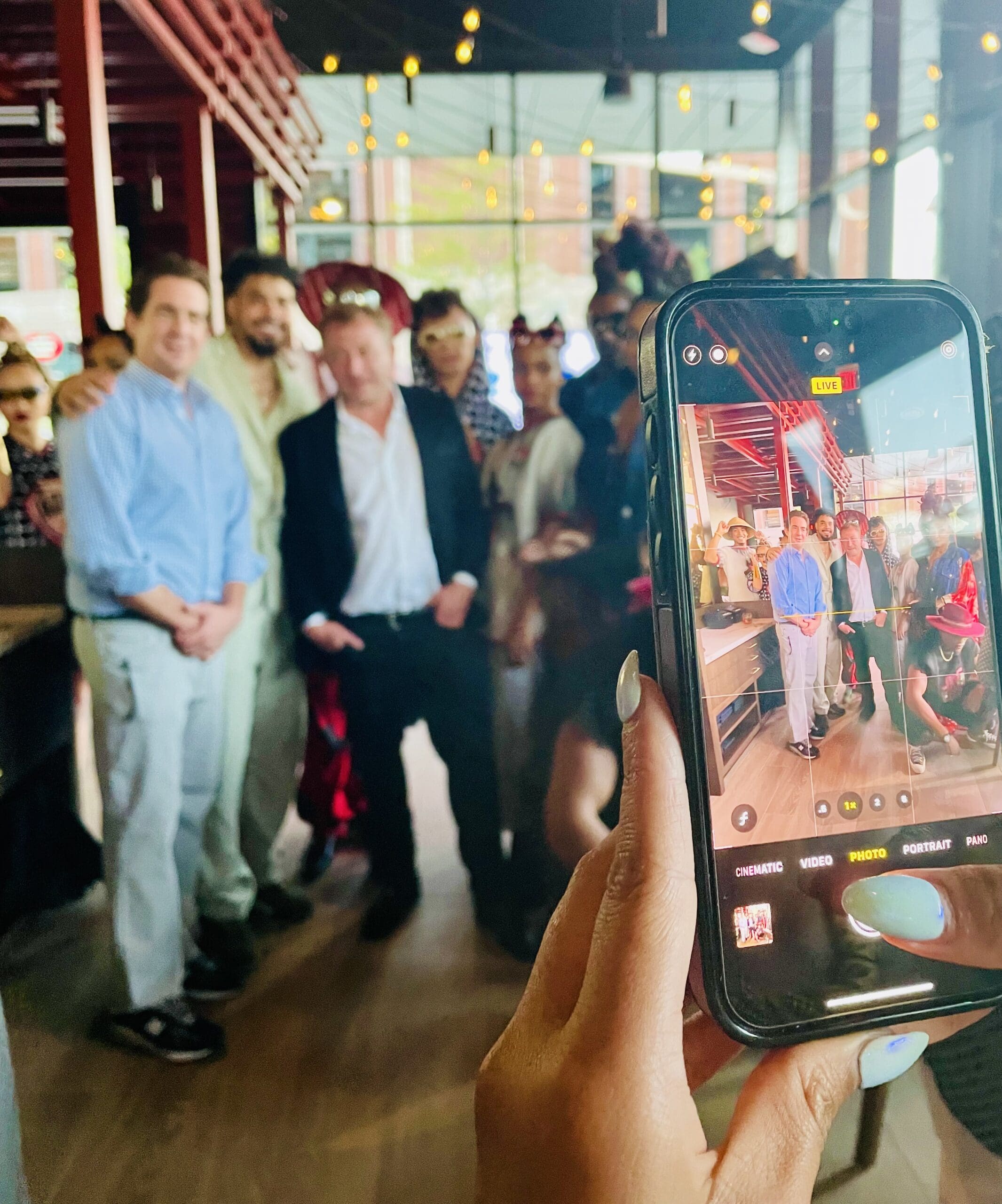 owner Ben Berg posing with fashion models and designer Dreux’ Hamm