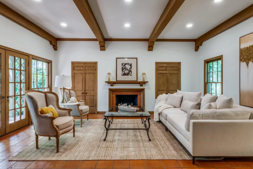 A cozy den with a wood burning fireplace.