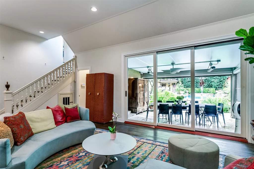 A view of the pool and backyard gardens from the living room.