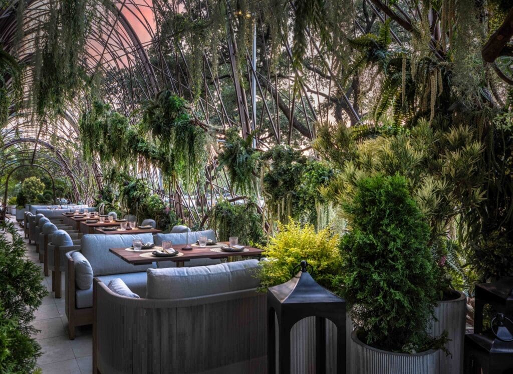 Drive down Allen Parkway to Toca Madera's entrance and you can’t help but notice the woven bronze-like art piece dubbed the bird’s nest that serves both as its engaging entry, as well as portico where under the cover of branches, hanging Spanish moss, willow leaves and wisteria vines intertwined within the airy metal cage. Photo by Connie Anderson.