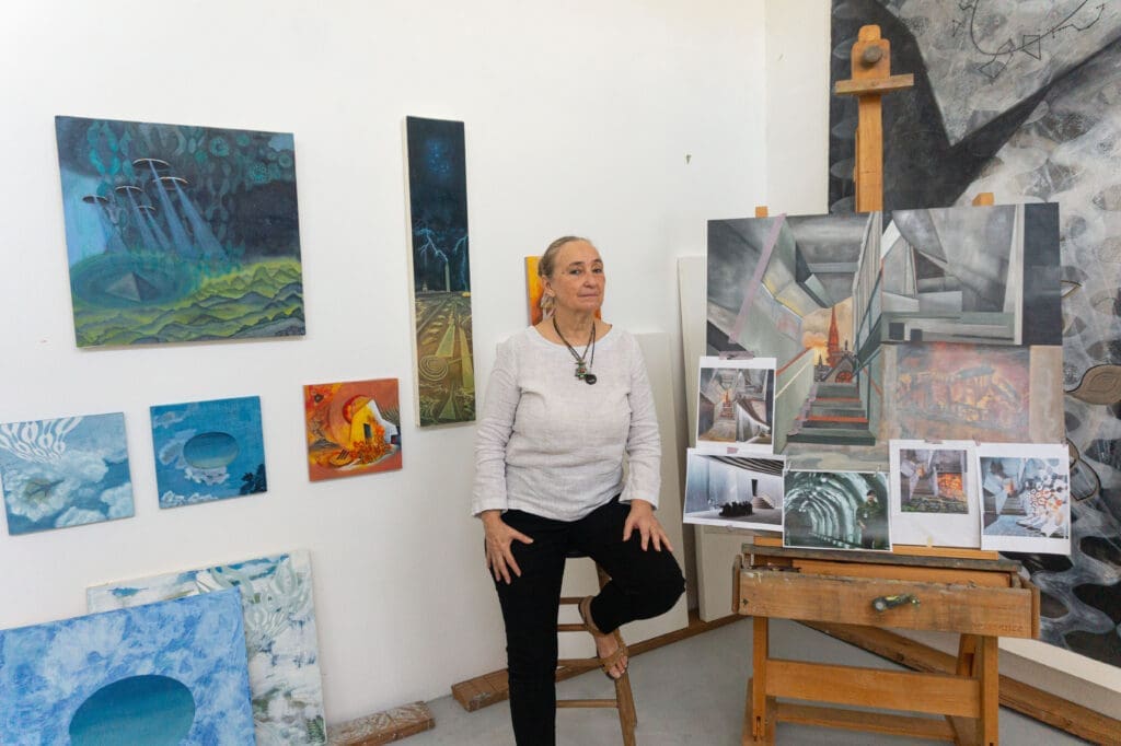 Arielle Masson surrounded by her paintings (Photo by Sofia Westerman) 