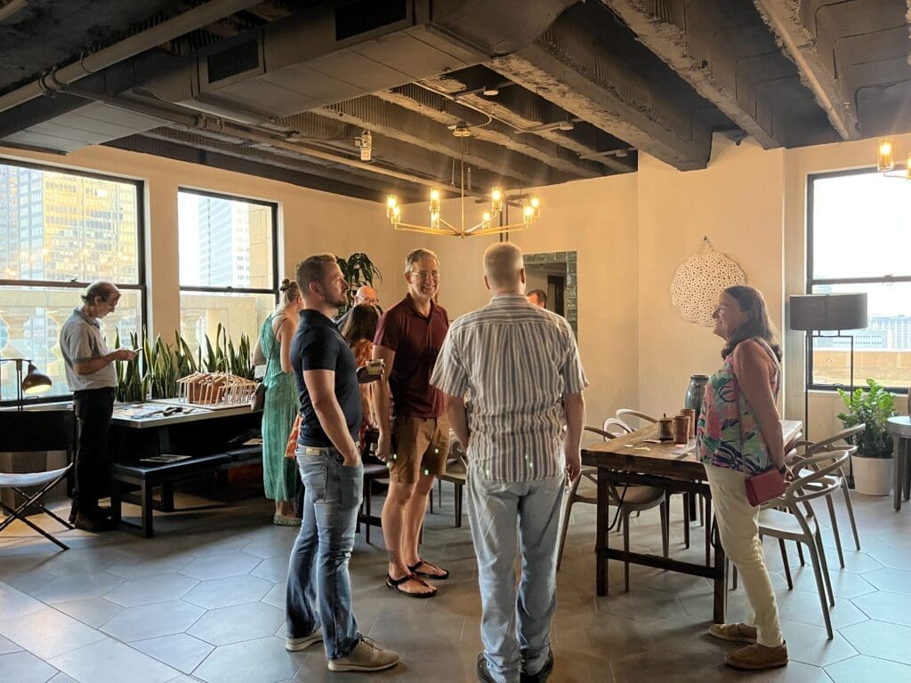Attendees admire Shane Tidmore's Raku pottery for sale at Kaze  Burning Man fundraiser at Esperson Building. (Photo by Jenna Baer)