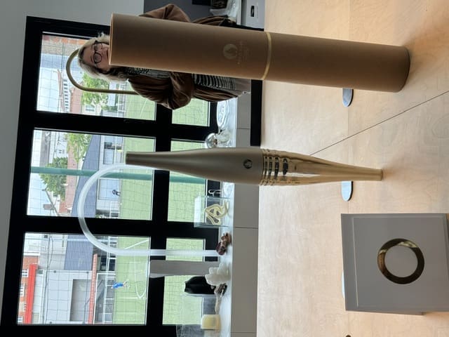 Visitors to Lehanneur's The Factory admire the 2024 Summer Olympics torch. (Photo by Donatella Benckenstein)