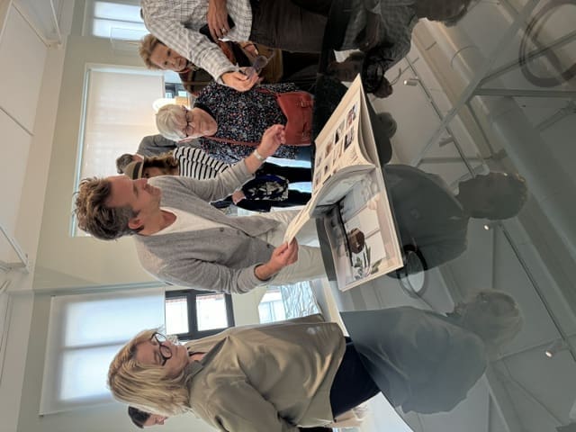 Mathieu Lehanneur shows visitors a lookbook of his designs at The Factory. (Photo by Donatella Benckenstein)
