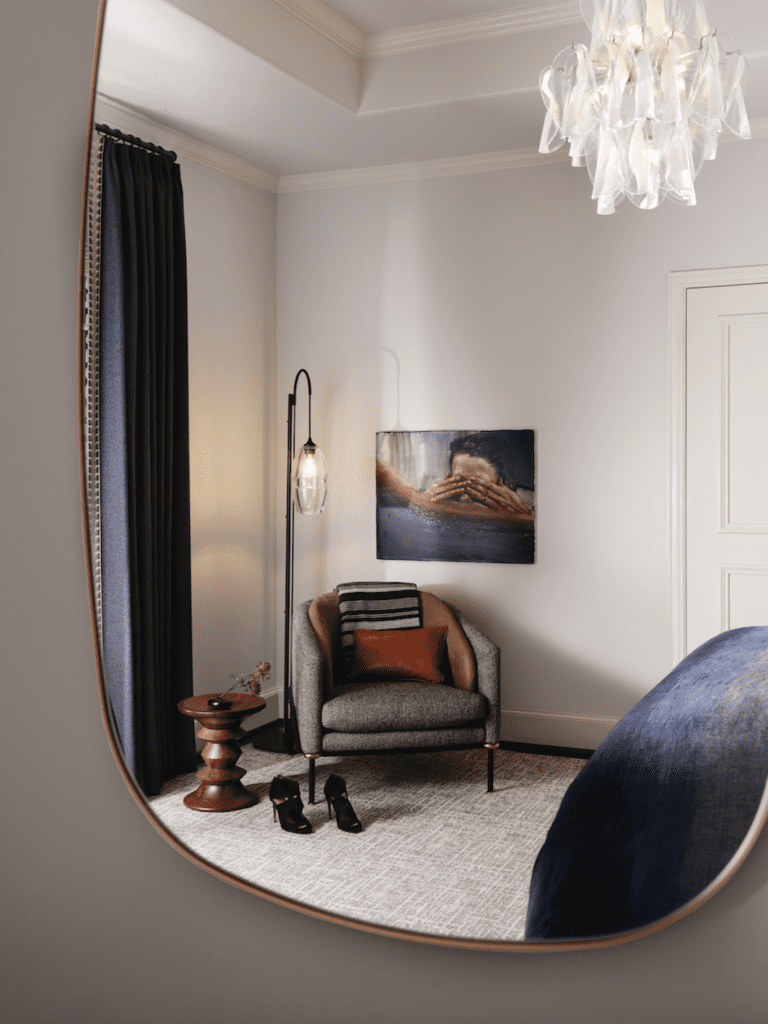 A side chair in the guest room is from Holly Hunt. Eames stool from DWR. Vintage Murano chandelier.  (Photo by Lisa Petrole)