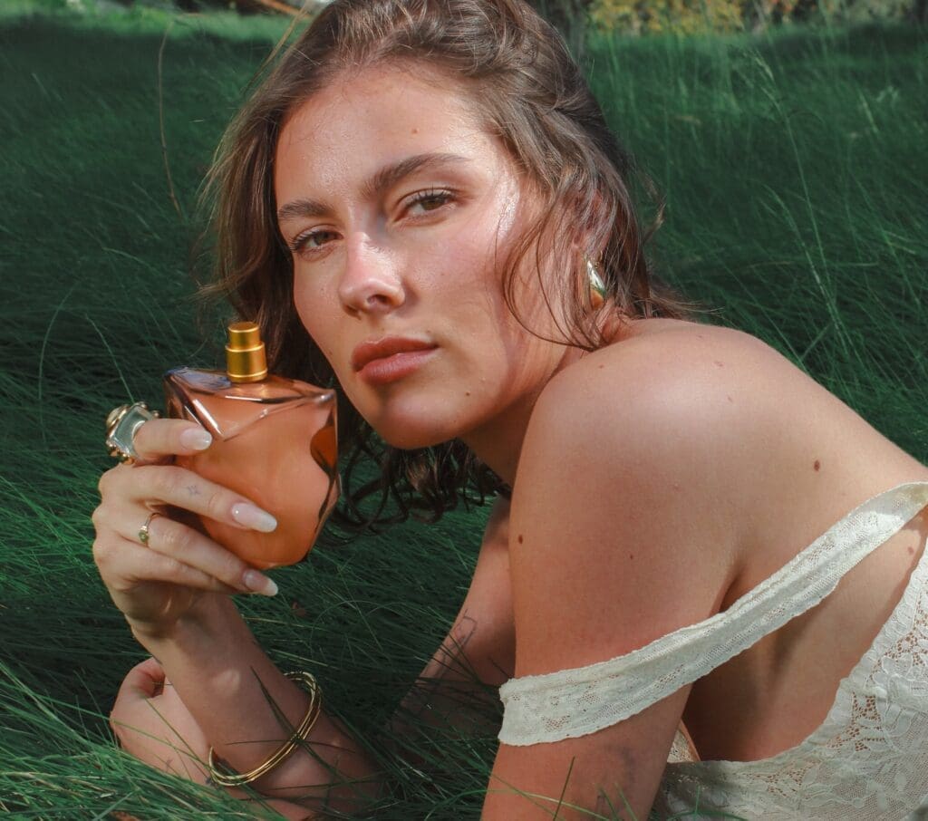 Model holds Window2Soul, one of three new clean fragrances from Bella Hadid's Orebella line.