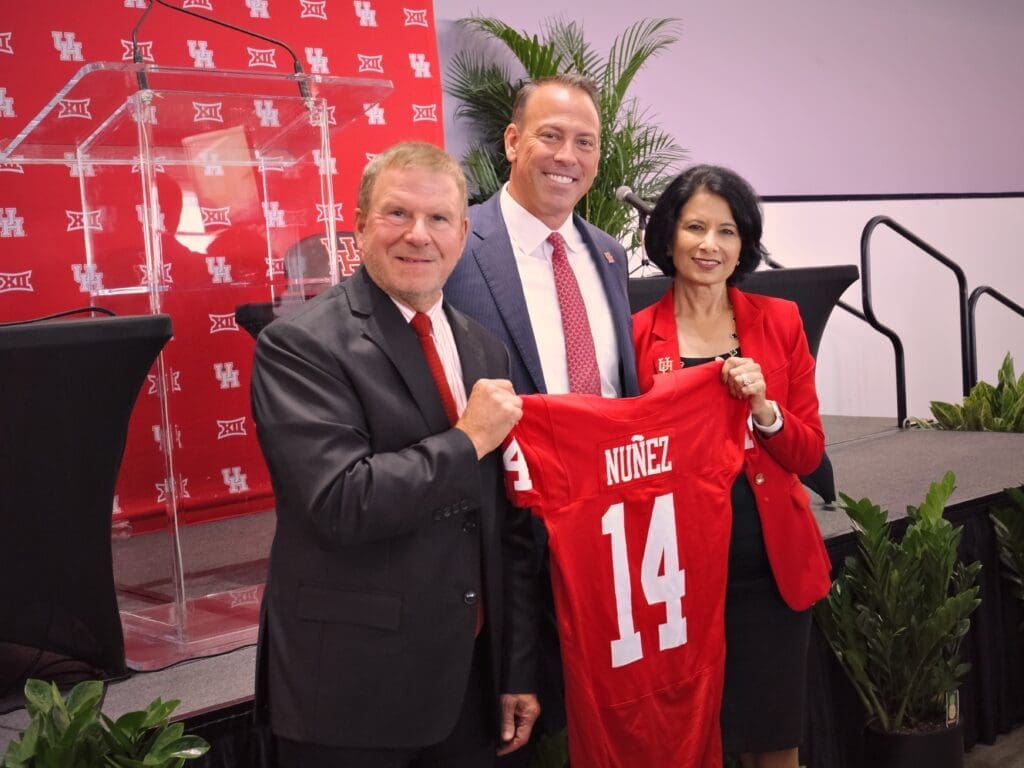 Tilman Fertitta, new University of Houston athletic director Eddie Nunez and Renu Khator have a UH moment. (Photo by F. Carter Smith)