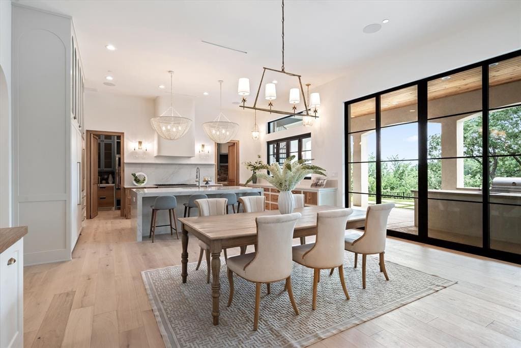 The kitchen takes in the sunny covered patio and peeks into the catering kitchen beyond the range wall.