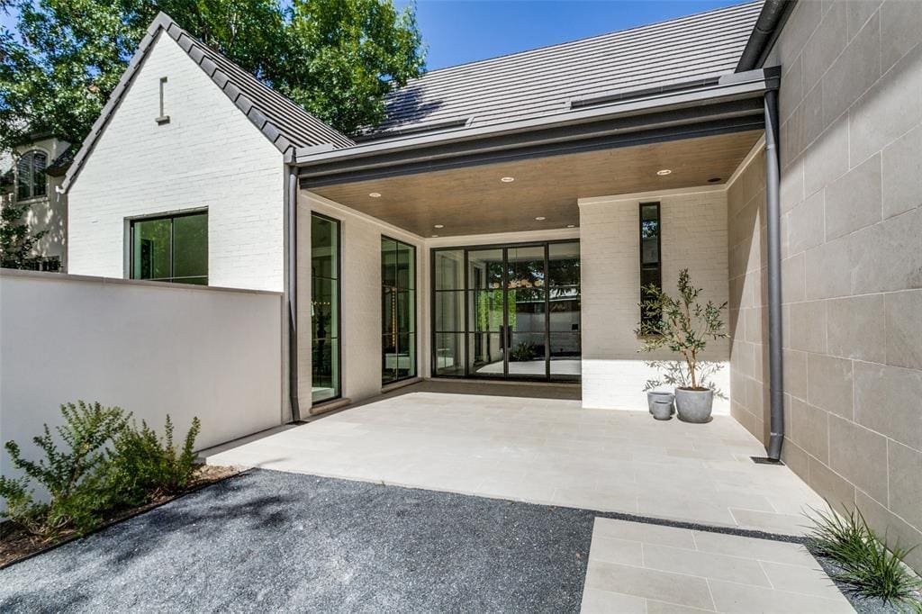 A concrete courtyard behind the privacy wall.