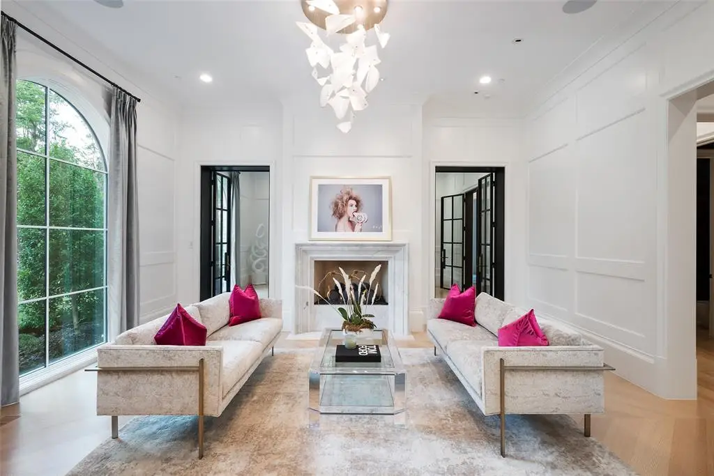 At 5414 Elden Drive, the formal living room flows through to the home office beyond.