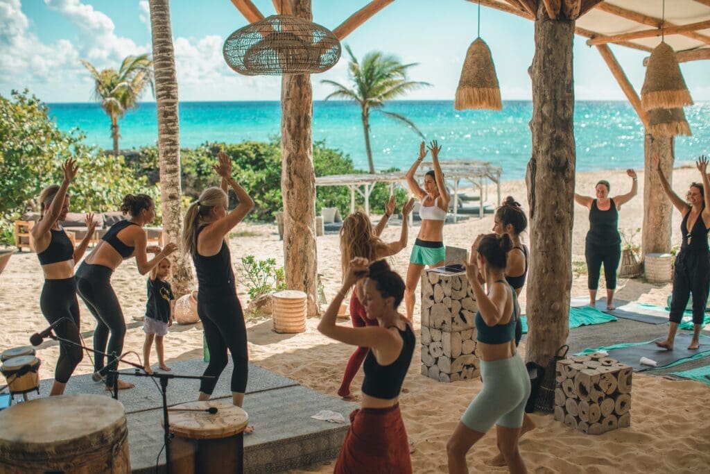 Wake up and meander to the beach and take in a morning yoga class outside at the Eolo Beach Club. (Photo courtesy Palmaïa-The House of Aïa) 