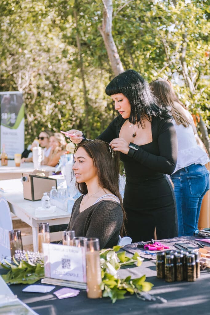 Sophie Chkaiban getting her hair done by Alexis Joubert at PaperCity's Nourish retreat. (Photo by Heather Robards)