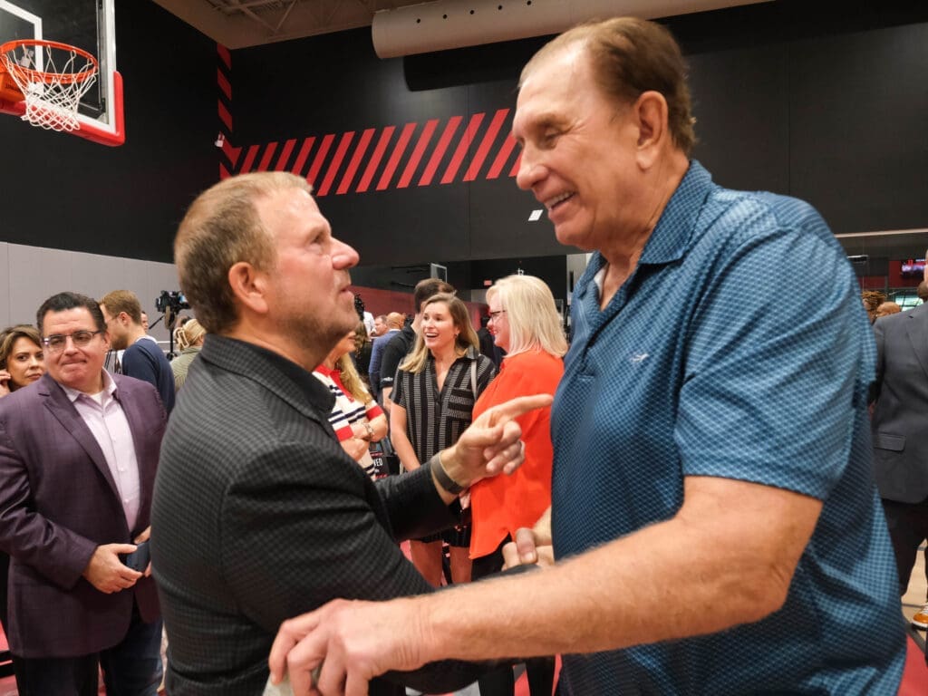 Houston Rockets owner Tilman Fertitta gave Rudy Tomjanovich a warm greeting. (Photo by F. Carter Smith)