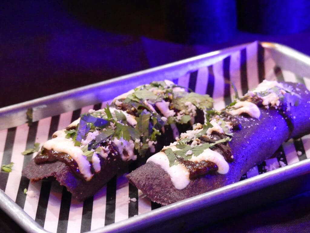 There are many spooky drinks and bites to try at the "Beetlejuice" pop-up at The Whippersnapper like Sandworm Tacos.