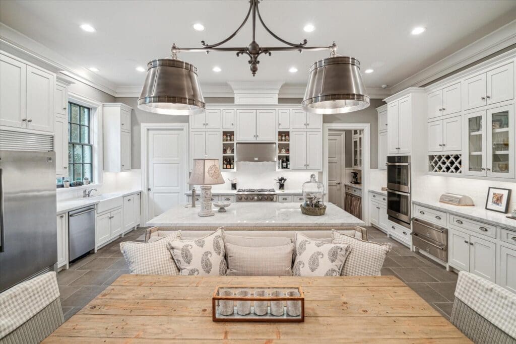 The gathering kitchen has ample cabinet space, marble countertops, and a dining ledge.