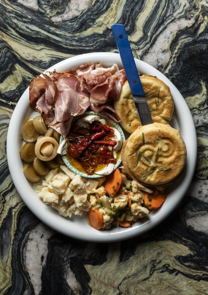 Kudos to the bread baker who creates the bounty found in the bread basket, from chewy focaccia to sesame seed-studded breadsticks and herb-crusted dinner rolls. The star of the bread program is the tigelle and salumi platter (shown here). (Photo by Julie Soefer)