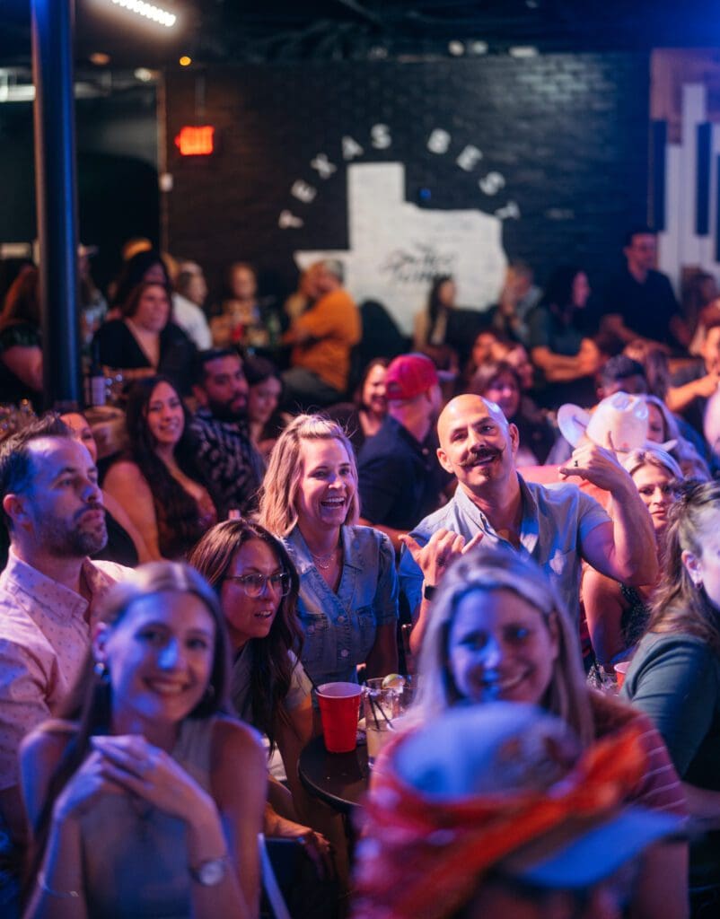 The crowd at Two Tones Dueling Piano Bar loves to enjoy music and sing along to their favorite requests. The bar's murals were painted by owner Tyler Lewis's mother. (Photo by JT Visuals)