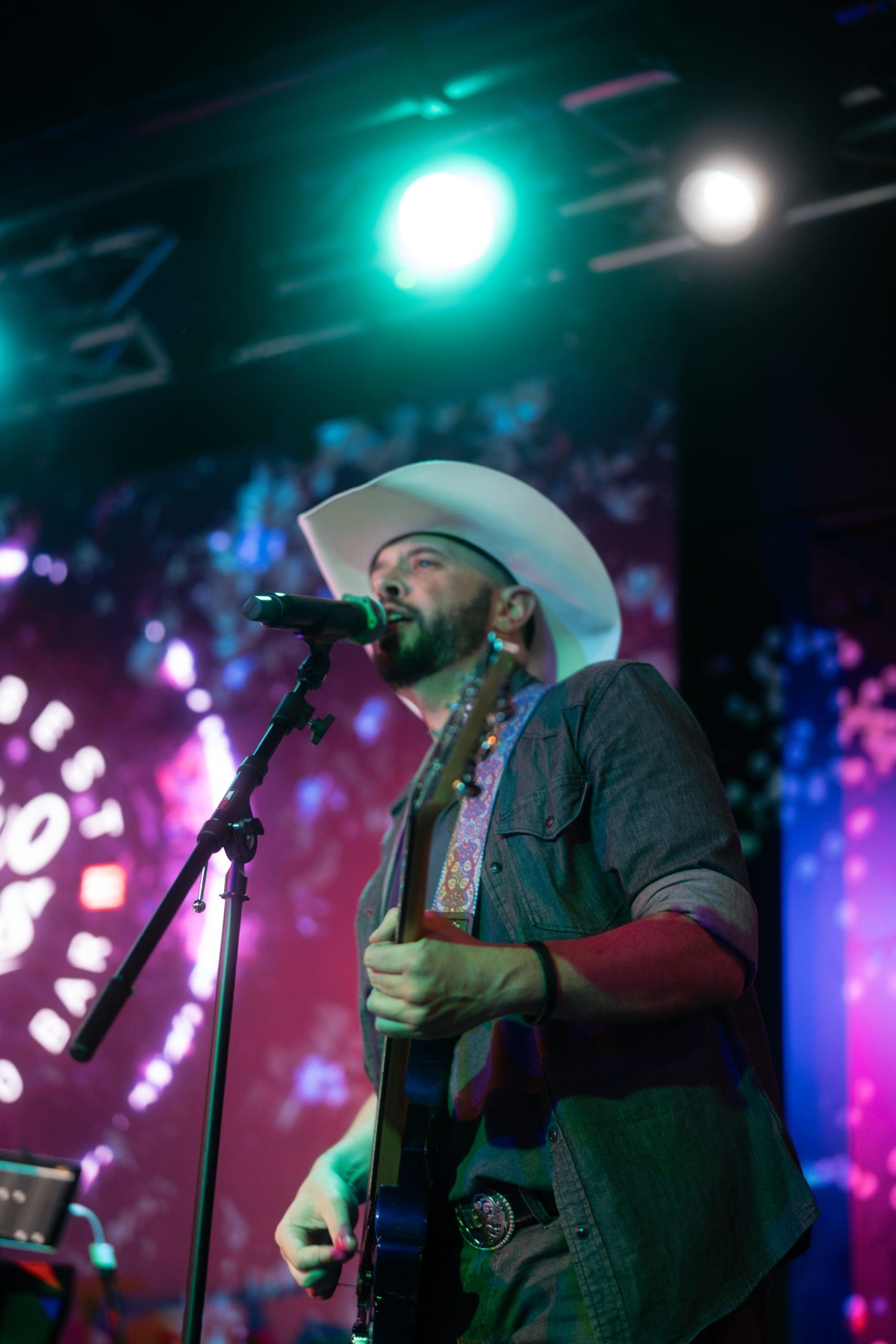 Designed specifically for the location, Two Tones Dueling Piano Bar allows the owners to customize lighting and sound throughout the space. Co-owner Josh Herod entertains the crowd on guitar. (Photo by JT Visuals)