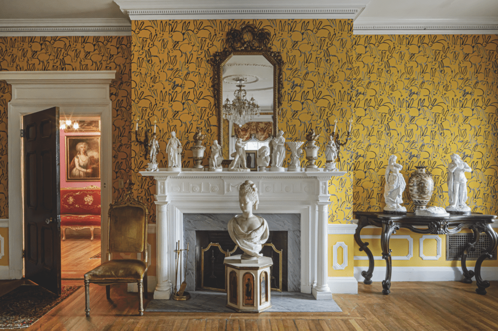 A bright yellow "Hutch" wallpaper for Lee Jofa brightens a bedroom in artist Hunt Slonem's restored Belle Terre, South Kortright, New York. The artist is one of America's greatest restorationists, with a tremendous portfolio of historic and important properties. (Photo by John Neitzel)