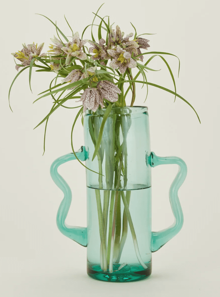 The Recycled Llorente Glass Vase is handcrafted from repurposed glass, offering a unique, eco-friendly addition to any space. (Photo courtesy Hawkins New York)
