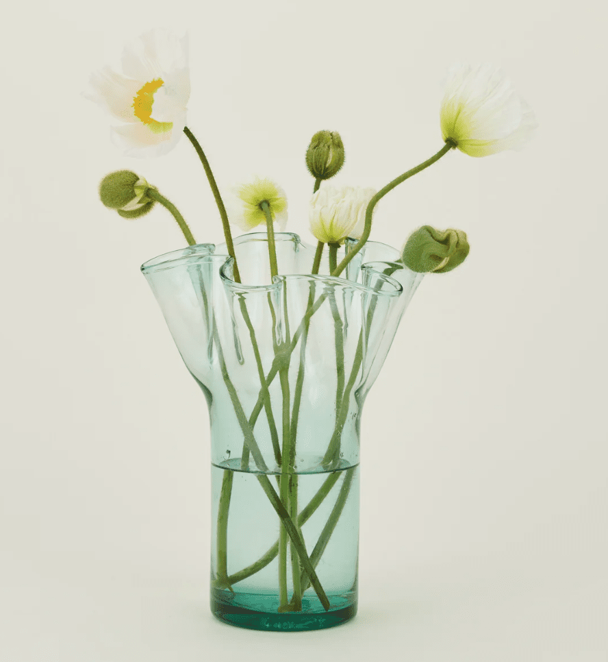 The Recycled Donaire Glass Vase is made from repurposed glass, featuring a one-of-a-kind design that adds a touch of artistry to any room. (Photo courtesy Hawkins New York)