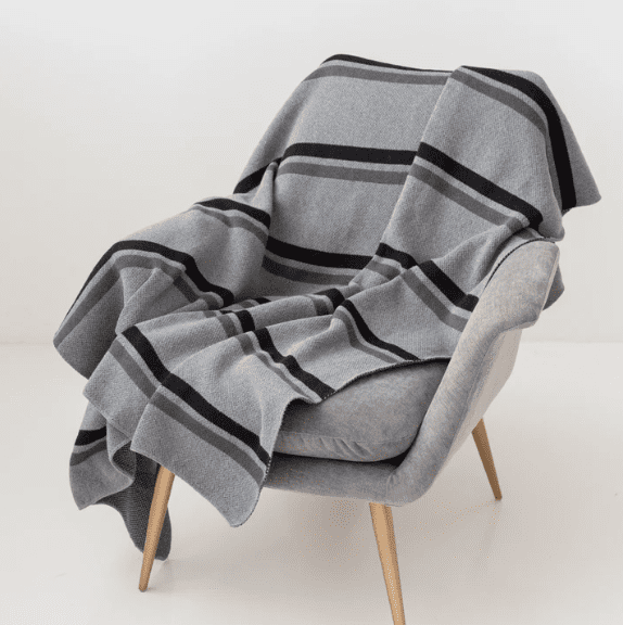 The Luxury Natural Throw Blanket is made from merino wool, recycled cotton, and cashmere for ultimate comfort and sustainability. (Photo courtesy Avocado Green Mattress)