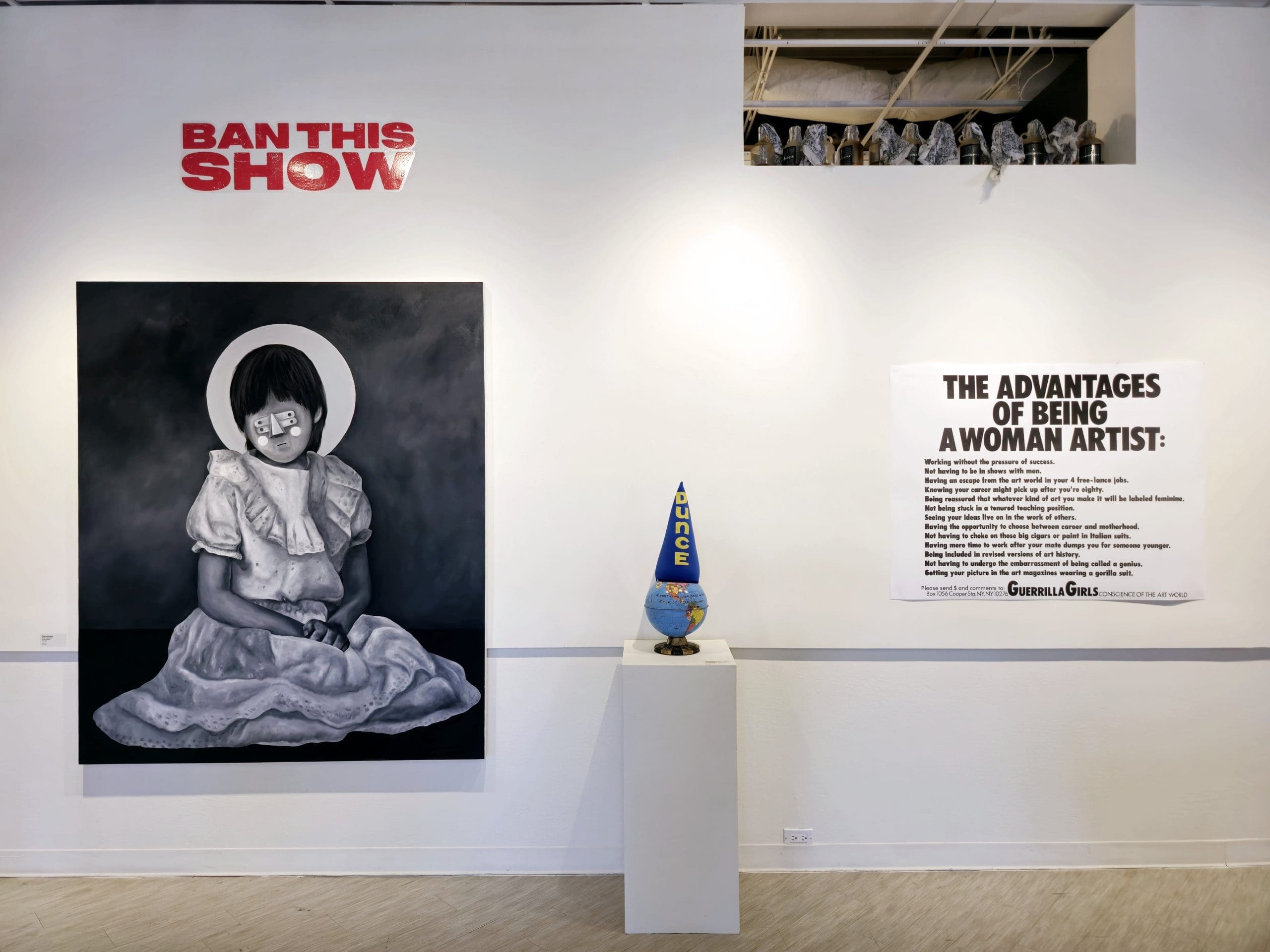 "Angel Baby" by Carlos DonJuan, "If There's Any Intelligence On Earth, It Must be in the Himalayas," and the Guerilla Girls' "The Advantages of Being A Woman Artist," greet gallery goers in "BAN THIS SHOW." (Photo by Brenda Ciardiello)