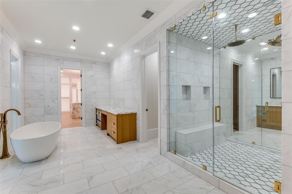 At 3917 Gillon Avenue, the primary suite features a private lounge, wet bar, two-way fireplace, bath, and steam shower. (Courtesy)