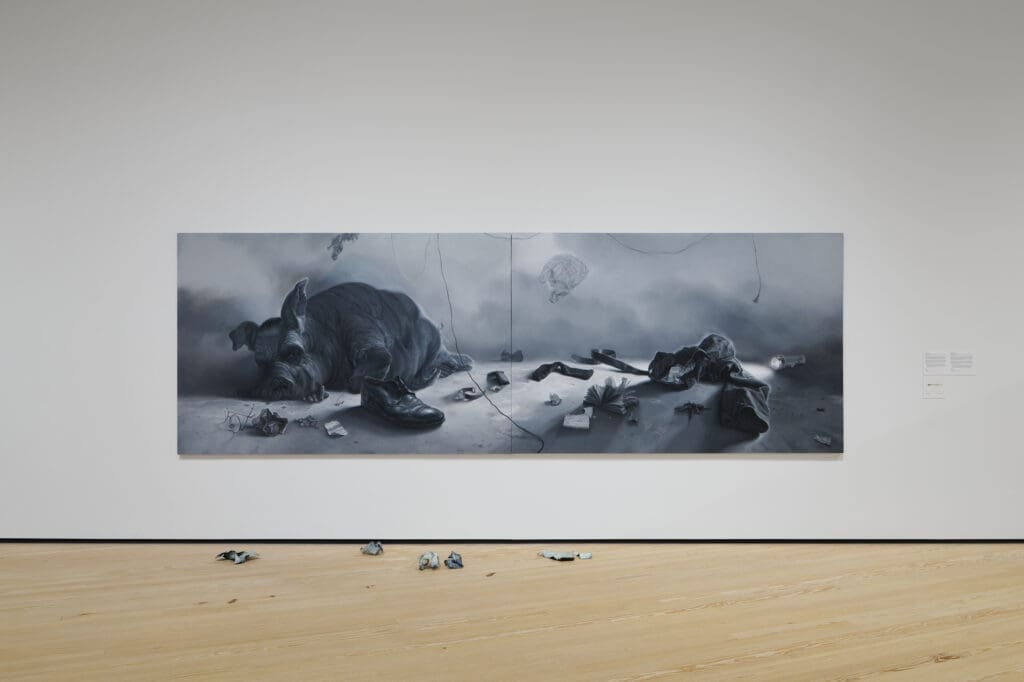 Vincent Valdez, Eaten (In America) (2018-19). Oil on canvas. A sixteen-foot diptych that critiques modern excess, featuring a pig (modeled after J. Edgar Hoover) in a barren, post-apocalyptic landscape. (Photo courtesy the artist)