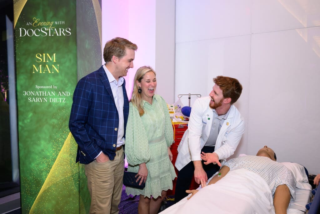 At An Evening with DocStars, 300 guests sipped cocktails while readily trying their hand at six interactive stations showcasing leading-edge technology from UT Southwestern. Pictured are Cameron and Megan Shepherd (Photo by Ren Morrison and Scott Booth)