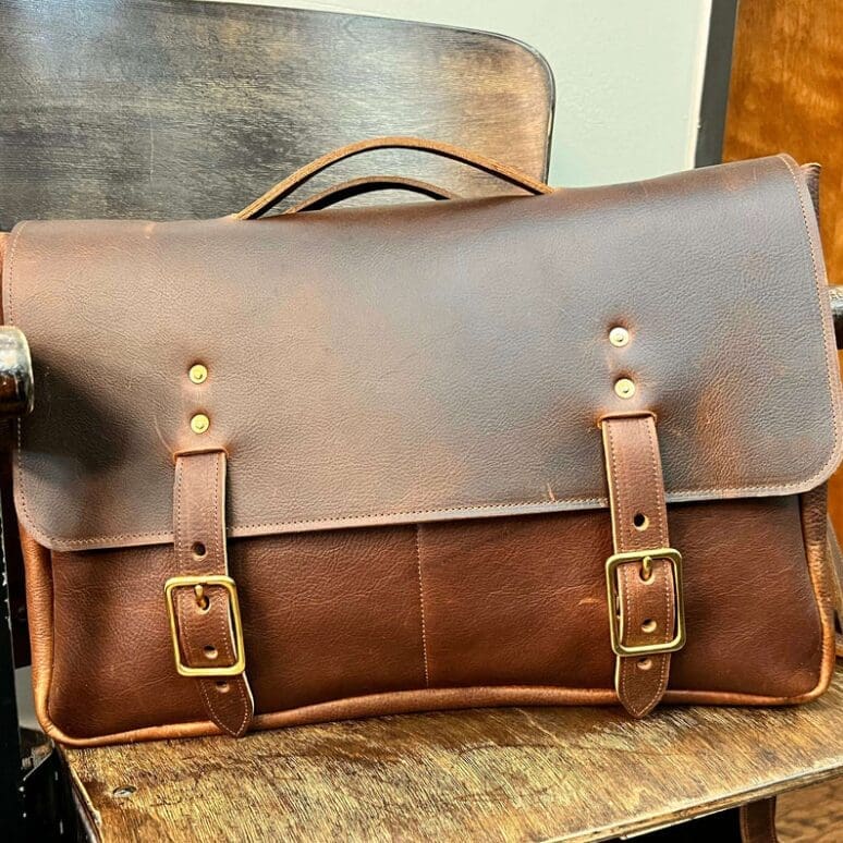 This classic satchel fits a 15" laptop, files, and essentials, with a matching shoulder strap for comfortable carrying. (Photo courtesy Odin Leather Goods)