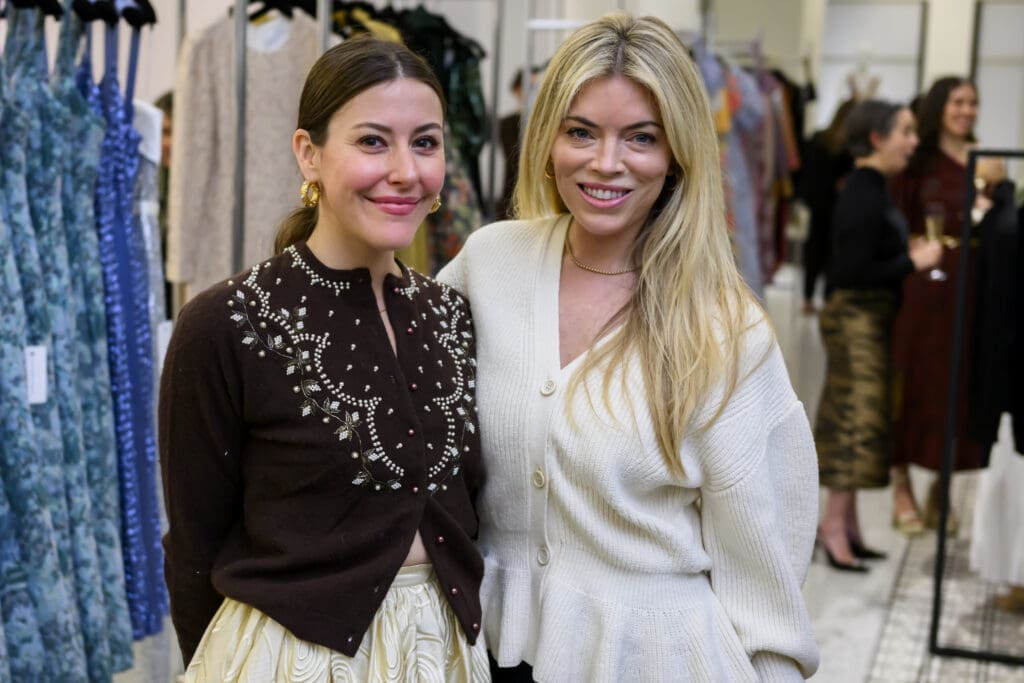 Designer Alexandra O’Neill poses with a party guest.