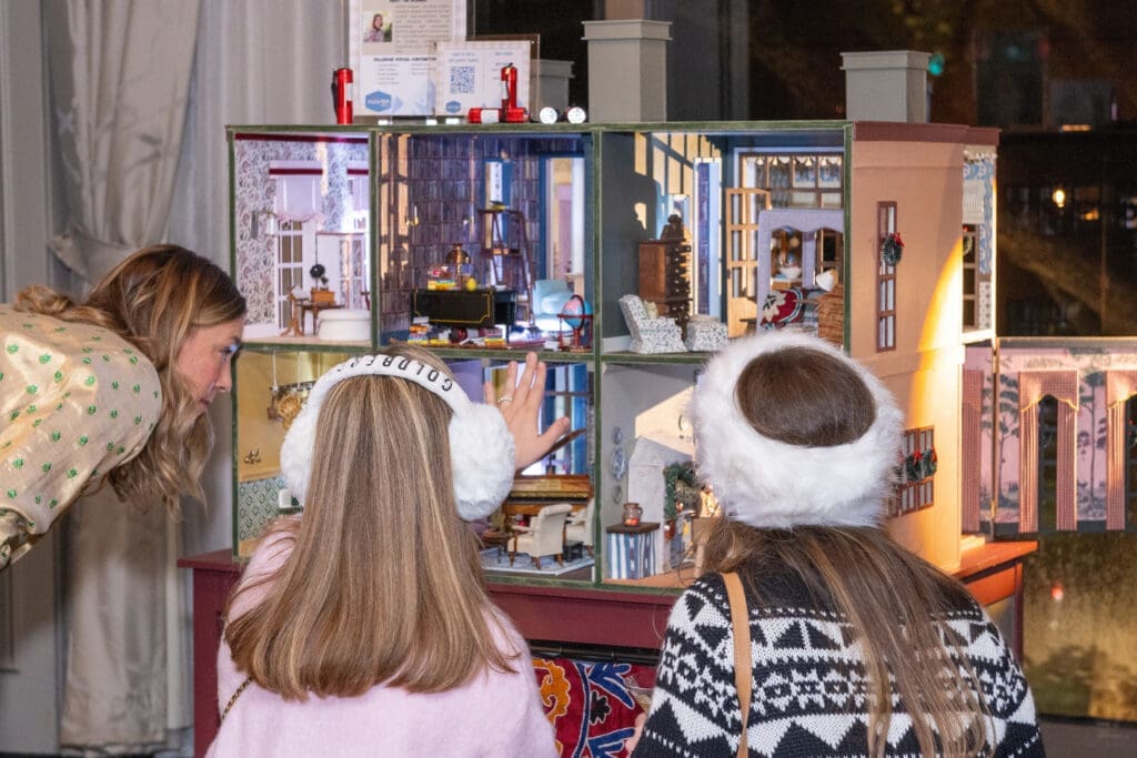 Guests inspecting the fine art of dollhouse design at La Petite Maison (Photo by Jacob Power)